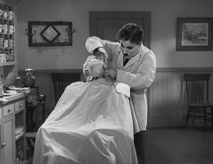 chaplin as the jewish barber giving a shave